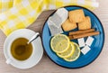 Cup of hot tea, sugar, cinnamon sticks, slices of lemon Royalty Free Stock Photo