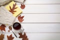 Cup of hot tea, sweater, book and autumn leaves on white wooden table, flat lay. Space for text Royalty Free Stock Photo