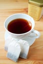 Cup of hot tea with teabags on a wooden table Royalty Free Stock Photo