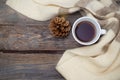 A cup of hot tea and a warm scarf on a wooden background. Flat l Royalty Free Stock Photo