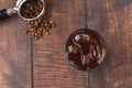 A cup of Iced Americano Coffee with ice cubes placed on a wooden table in a coffee shop. Top view of a glass of coffee Royalty Free Stock Photo