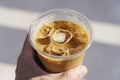 Cup of iced latte cappuccino coffee in hand on city street. Takeaway coffee drink Royalty Free Stock Photo