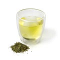 Cup of Japanese green tea and a heap of dried green tea leaves Royalty Free Stock Photo