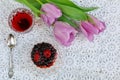 Cup of karkadeh red tea with berries cake and tulips Royalty Free Stock Photo