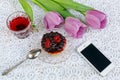 Cup of karkadeh red tea with berries cake and tulips Royalty Free Stock Photo