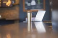 Thermos cup & laptop on table inside a coffee shop Royalty Free Stock Photo