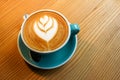 A cup latte art coffee on wood table Royalty Free Stock Photo