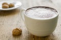 Cup of latte coffee with biscotti on wooden table Royalty Free Stock Photo