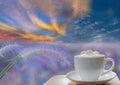 Cup of latte coffee with soft blurred desho grass, Mauritius Grass, Poaceae, flower with dew and fog, with beautiful sky Royalty Free Stock Photo