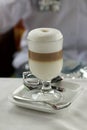 A cup of latte macchiato on the table with white tablecloth Royalty Free Stock Photo