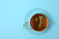 Cup of linden tea on blue background top view Royalty Free Stock Photo