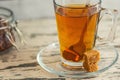 Cup of Linden tea with cane sugar on grey wooden background. Close Up Royalty Free Stock Photo