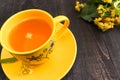 Cup with linden tea and flowers on wooden table Royalty Free Stock Photo