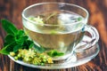 Cup of linden tea on wooden table still life