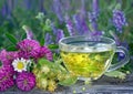 Cup of linden tea on a wooden table. white butterfly sitting on a cup of herbal tea. clover flowers and a cup of flower tea. herba