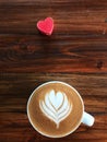 Cup of love , heart latte art coffee in white cup and red love heart Royalty Free Stock Photo