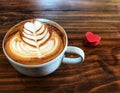 Cup of love , heart latte art coffee in white cup and red love heart Royalty Free Stock Photo