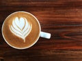 Cup of love , heart latte art coffee in white cup on the vintage wooden Royalty Free Stock Photo