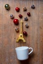 Cup on lying on side with Eiffel tower toy and Christmas baubles