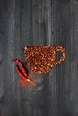 Cup made of coffee beans with chili pepper Royalty Free Stock Photo