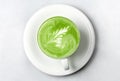 Cup of matcha green tea latte over white