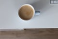 Cup of milk coffee on white table, still life flat lay with space for text Royalty Free Stock Photo
