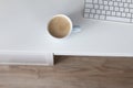 Cup of milk coffee on white table, still life flat lay with space for text Royalty Free Stock Photo