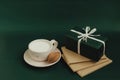 Cup with milk, cookies and gift on a green background. Minimalistic greeting cards and envelopes. Christmas and New Year