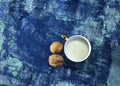 Cup of milk with walnuts  on blue background Royalty Free Stock Photo