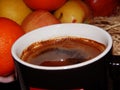 A cup of morning black coffee with fruits in the background Royalty Free Stock Photo