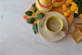 Cup of morning coffee, cappuccino and bouquet of yellow roses on wooden background, flat lay, top view. Space for text Royalty Free Stock Photo