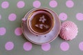 A cup of morning tea with pink meringue