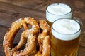 Cup of mugs of light beer, pretzels on the wooden background. Beer and pretzels as symbol of October fest Royalty Free Stock Photo