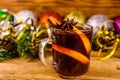 Cup of mulled wine with cinnamon, christmas decorations and fir tree branches on wooden table Royalty Free Stock Photo