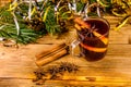 Cup of mulled wine with cinnamon, christmas decorations and fir tree branches on wooden table Royalty Free Stock Photo