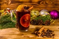 Cup of mulled wine with cinnamon, christmas decorations and fir tree branches on wooden table Royalty Free Stock Photo