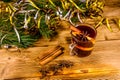 Cup of mulled wine with cinnamon, christmas decorations and fir tree branches on wooden table Royalty Free Stock Photo