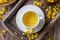 A cup of mullein tea with fresh verbascum, top view