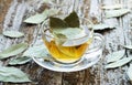 Cup of natural bay leaf herbal tea on wooden table Royalty Free Stock Photo