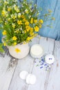 cup with natural homemade milk and sweet marshmallows on a wooden background. A bouquet of wildflowers and summer mood, Royalty Free Stock Photo