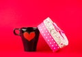 Cup near gift on red background, concept of valentine day Royalty Free Stock Photo