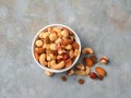 Cup with nuts and dried fruits on a gray background, close-up. Royalty Free Stock Photo