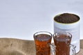 A cup of organic black tea with garden-fresh processed leaves in a stylish can, captured in a close-up. Perfect for advt. Royalty Free Stock Photo