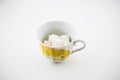 A cup with pieces of sugar Unhealthy food Harm
