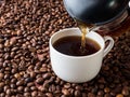 Cup and pot of coffee on coffee beans background Royalty Free Stock Photo