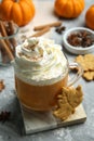 Cup of pumpkin spice latte with whipped cream, cookies and ingredients on light grey table, closeup Royalty Free Stock Photo