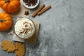 Cup of pumpkin spice latte with whipped cream, cookies and ingredients on light grey table, flat lay. Space for text Royalty Free Stock Photo