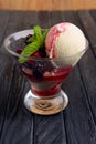 A cup of raspberries ice cream decorated with dewberry and mint leaves Royalty Free Stock Photo