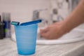 Cup with a razer on it and man washing his hahds on a background