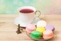 Cup of red tea and colored cakes Royalty Free Stock Photo